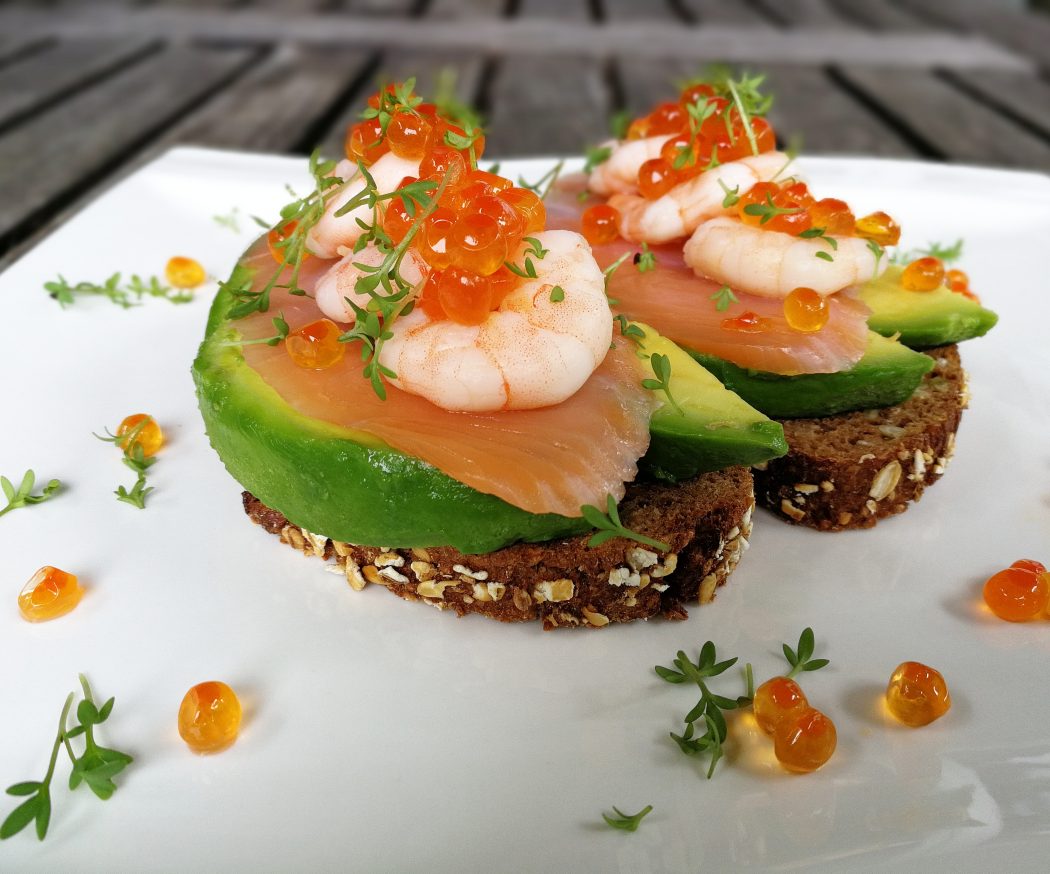 Avocado with shrimps, salmon and caviar